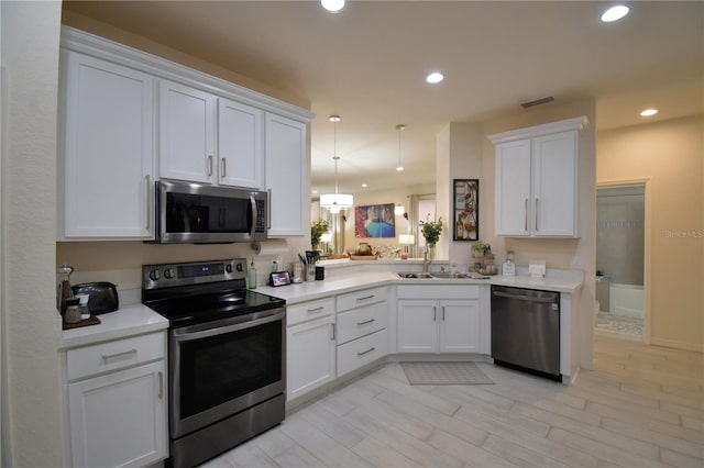 kitchen featuring white cabinets, sink, light wood-type flooring, and stainless steel appliances