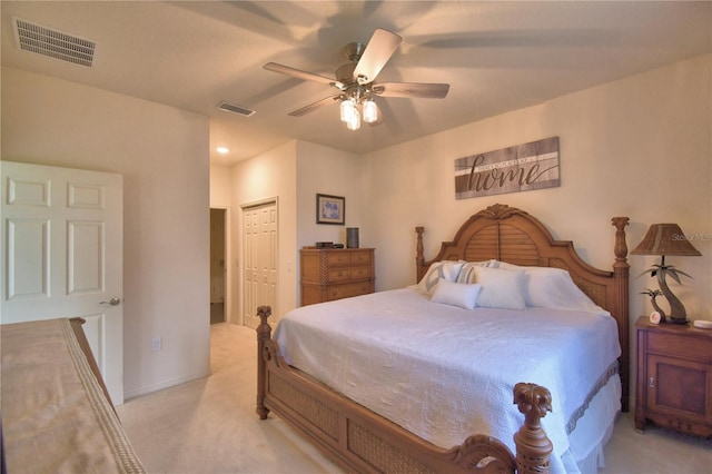 carpeted bedroom featuring ceiling fan and a closet