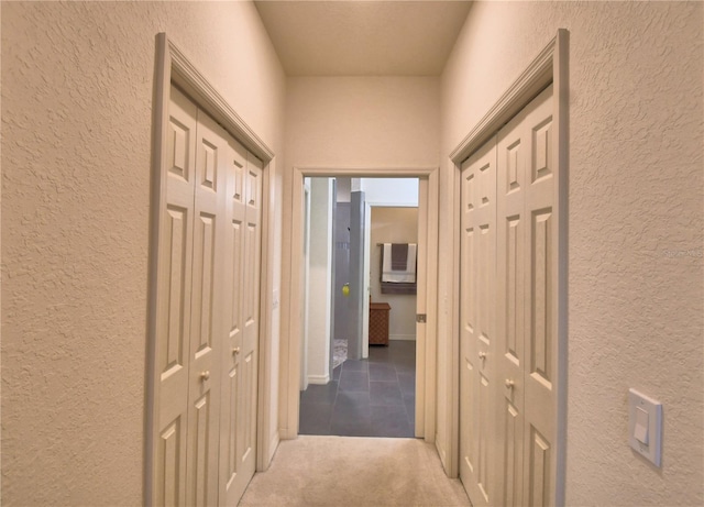 hallway with carpet floors