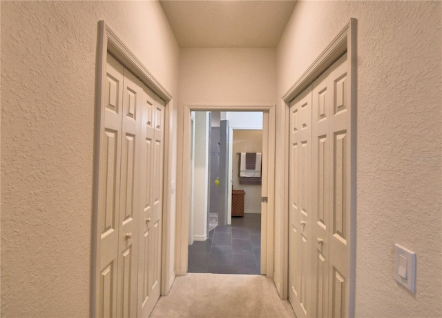 1644 Linz Ct, Winter Haven, FL 33884 - corridor featuring a textured wall, tile patterned floors, and carpet floors