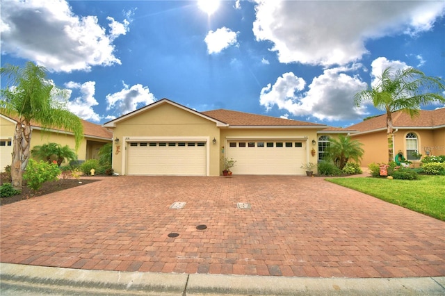 1644 Linz Ct, Winter Haven, FL 33884 - ranch-style house featuring an attached garage, stucco siding, and decorative driveway