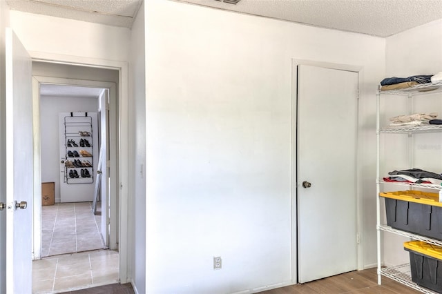 interior space with a textured ceiling and light wood-type flooring