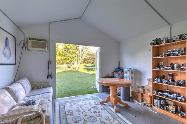 living area with an AC wall unit, concrete flooring, and lofted ceiling