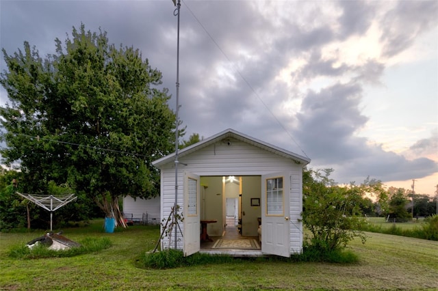 back of house with a lawn