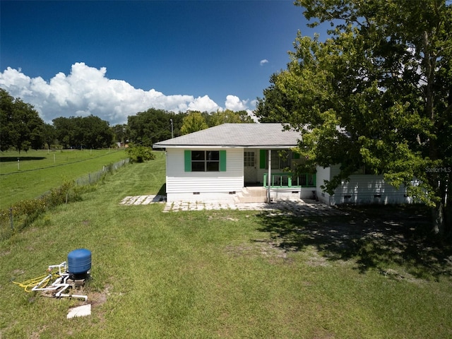 rear view of property with a yard and a patio