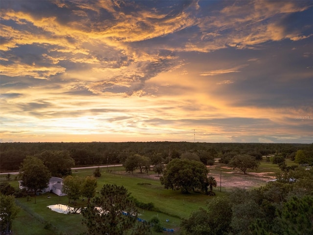 aerial view at dusk featuring a rural view