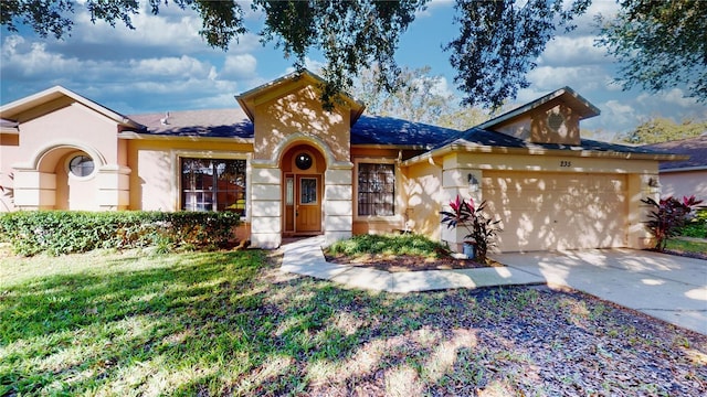 view of front of property featuring a garage and a front lawn