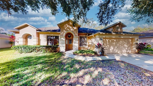 view of front of property featuring a front yard and a garage