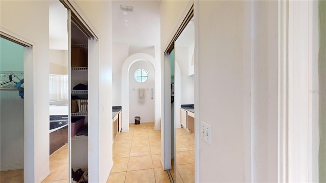 corridor with light tile patterned floors