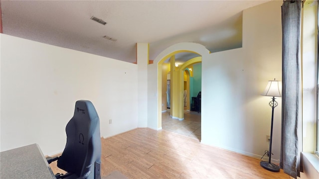 unfurnished office featuring light hardwood / wood-style floors