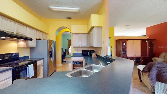 kitchen featuring black appliances, light tile patterned floors, sink, and cream cabinets