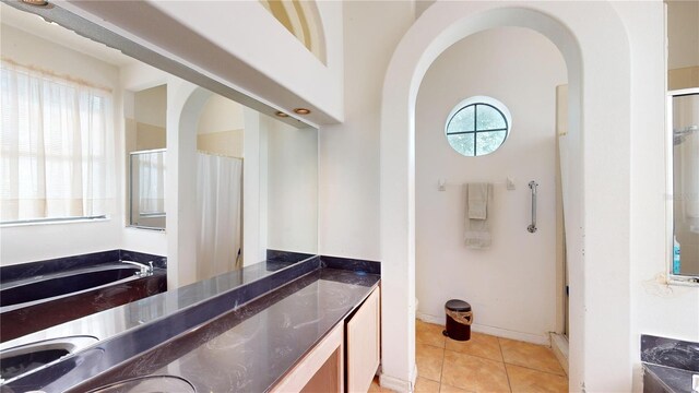 bathroom featuring tile patterned flooring, separate shower and tub, and vanity