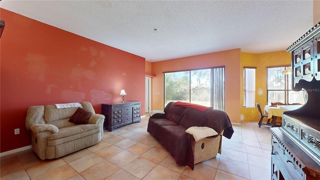 living room featuring a textured ceiling and light tile patterned floors