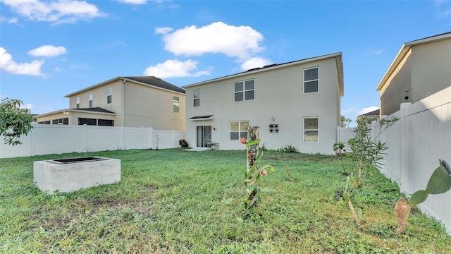 rear view of property with a lawn