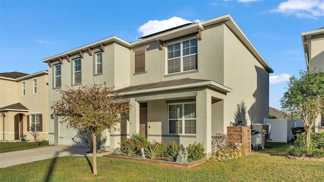 view of front of property with a front yard and a garage