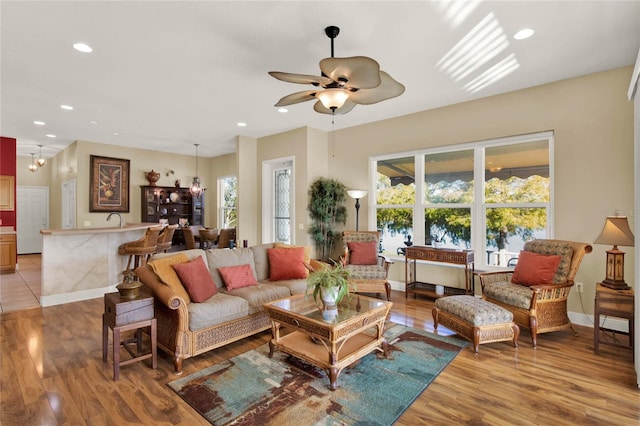 living room featuring light wood-type flooring and ceiling fan