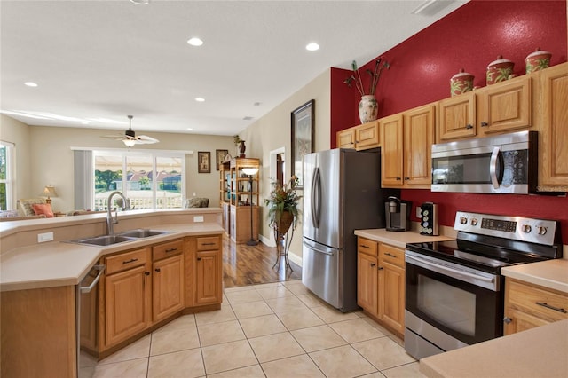 kitchen featuring ceiling fan, light tile patterned flooring, sink, and appliances with stainless steel finishes