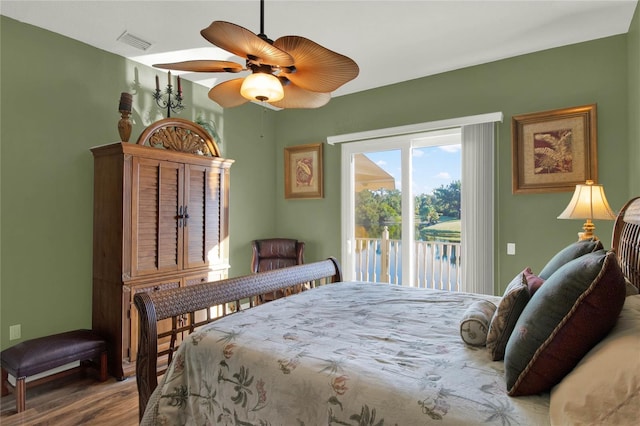 bedroom with hardwood / wood-style floors, ceiling fan, and access to outside