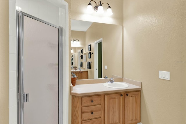 bathroom with vanity and a shower with door