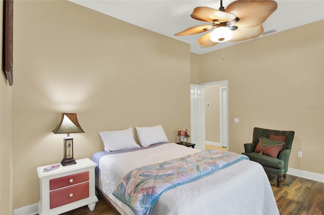 bedroom with ceiling fan and dark hardwood / wood-style flooring