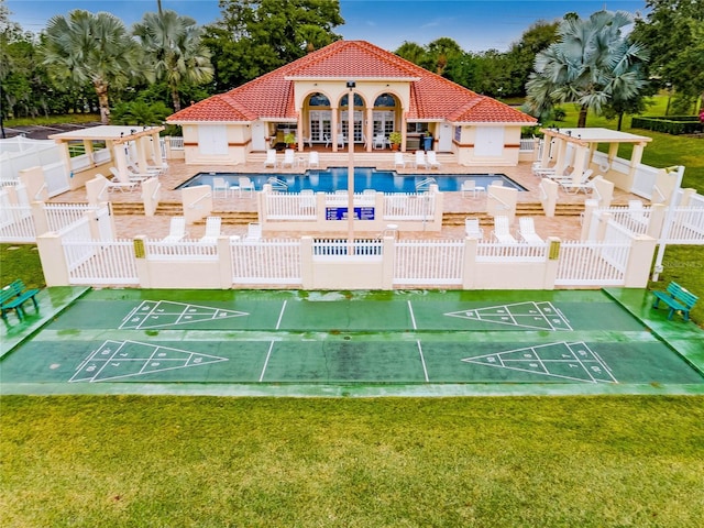 view of community with a pool and a yard