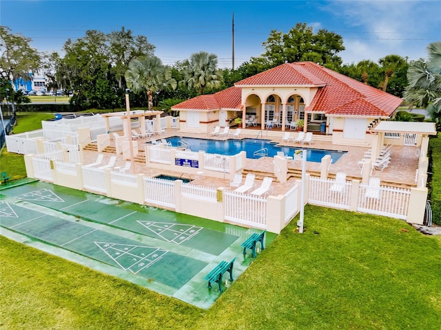 view of pool with a lawn and a patio area