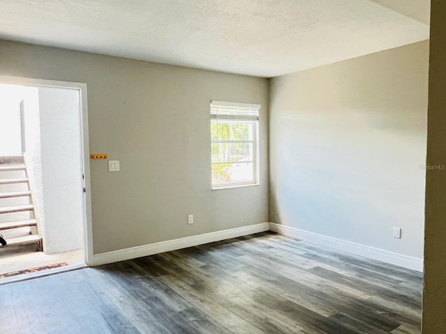 7108 Waterside Dr Unit 103, Tampa, FL 33617 - unfurnished room with dark wood-style floors and baseboards
