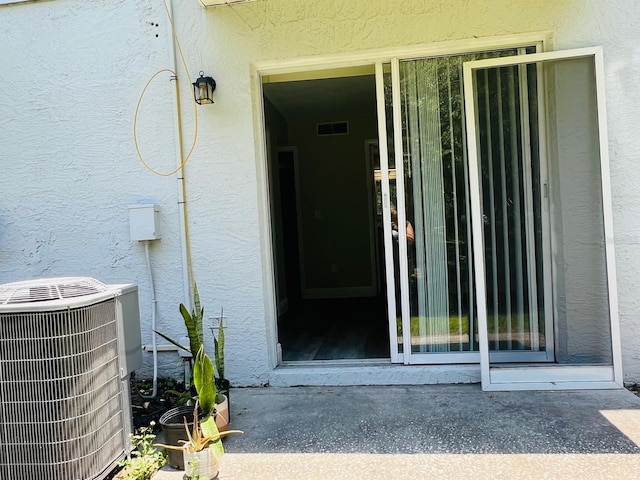 property entrance featuring central AC unit