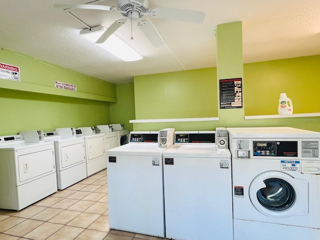 clothes washing area featuring light tile patterned floors, a textured ceiling, separate washer and dryer, and ceiling fan