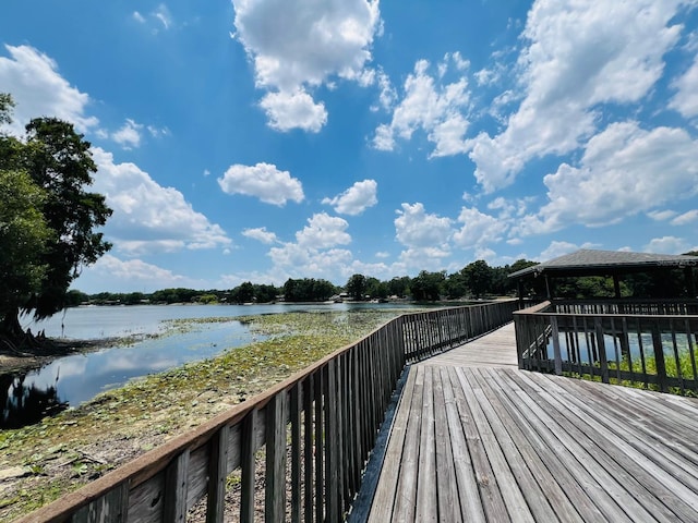 wooden terrace featuring a gazebo and a water view