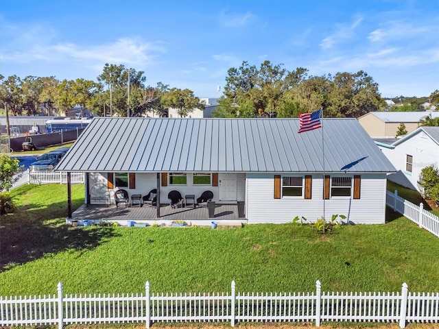 rear view of property featuring a lawn