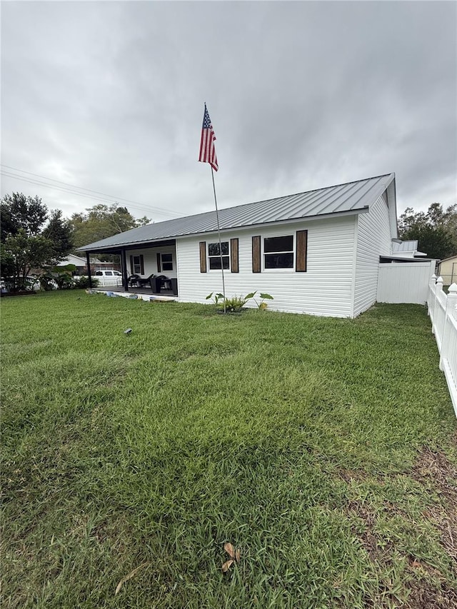 view of front of home with a patio area and a front yard