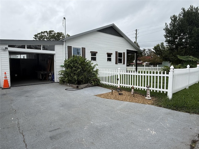 view of side of property with a garage and a lawn