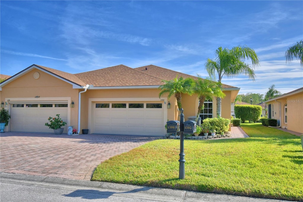 view of front facade with a garage and a front yard