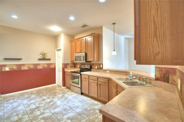 kitchen featuring pendant lighting, light tile patterned floors, sink, and appliances with stainless steel finishes