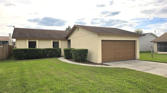 single story home featuring a garage and a front lawn