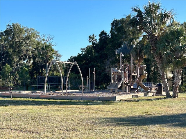 view of property's community featuring a yard and a playground