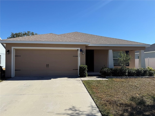 view of front facade with a front lawn and a garage