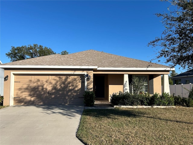 view of front facade featuring a front yard and a garage