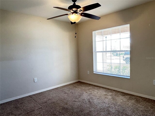 unfurnished room with ceiling fan and carpet flooring