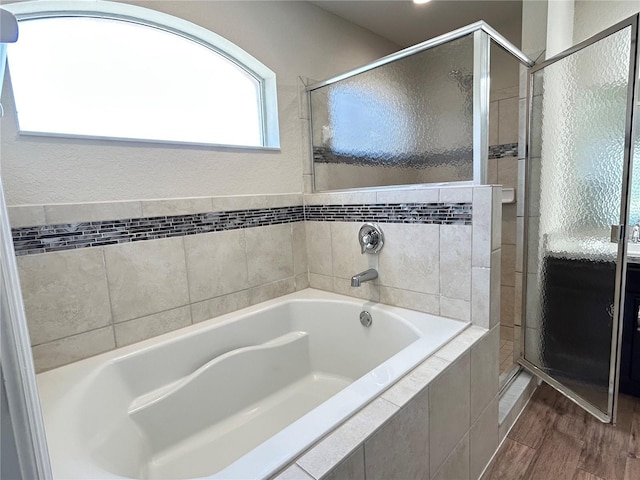 bathroom with separate shower and tub and hardwood / wood-style flooring