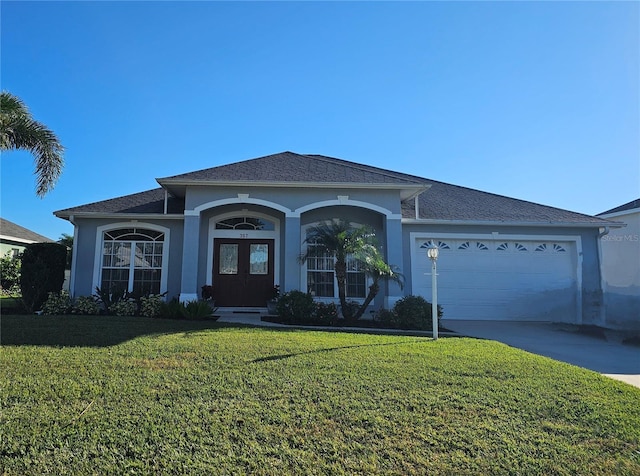 single story home featuring a garage and a front yard