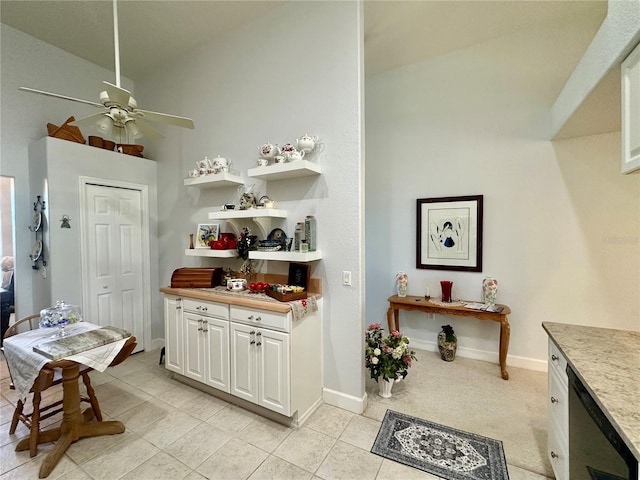 kitchen with ceiling fan, dishwasher, white cabinetry, and light tile patterned floors