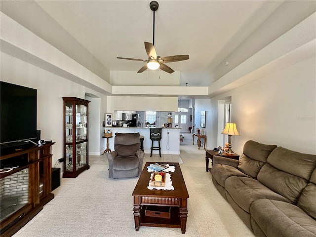 living room featuring ceiling fan and light colored carpet