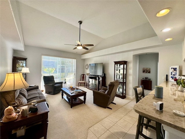 carpeted living room featuring vaulted ceiling and ceiling fan