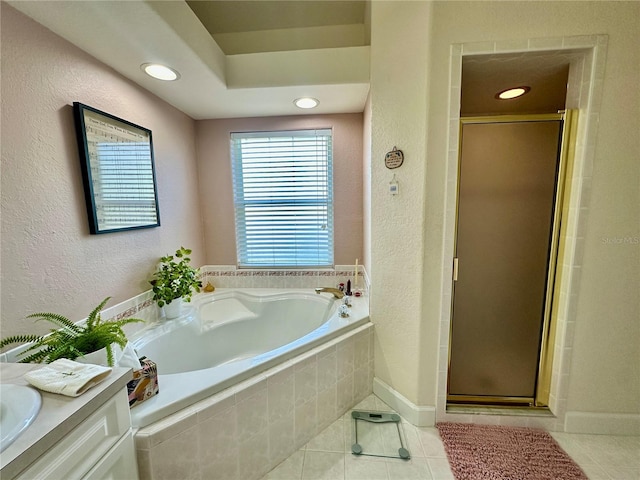 bathroom featuring vanity, tile patterned flooring, and plus walk in shower