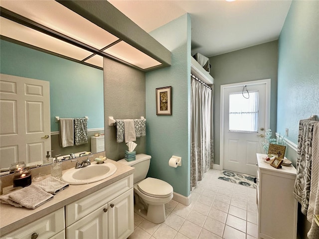 bathroom with tile patterned flooring, vanity, and toilet