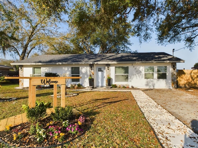 ranch-style home featuring a front yard