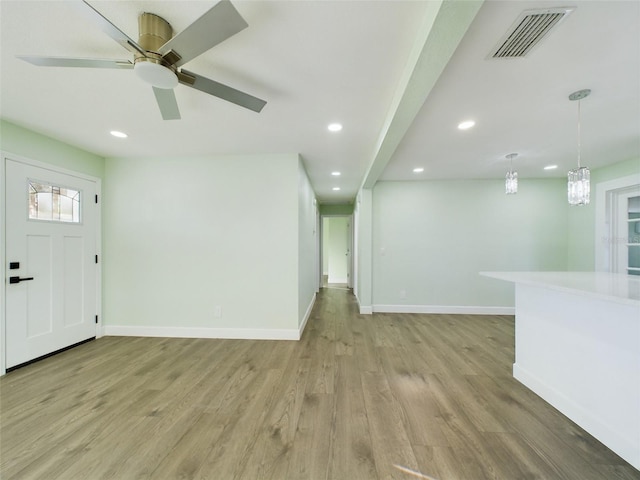 foyer with light hardwood / wood-style floors and ceiling fan