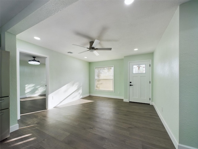 foyer featuring dark wood-type flooring and ceiling fan